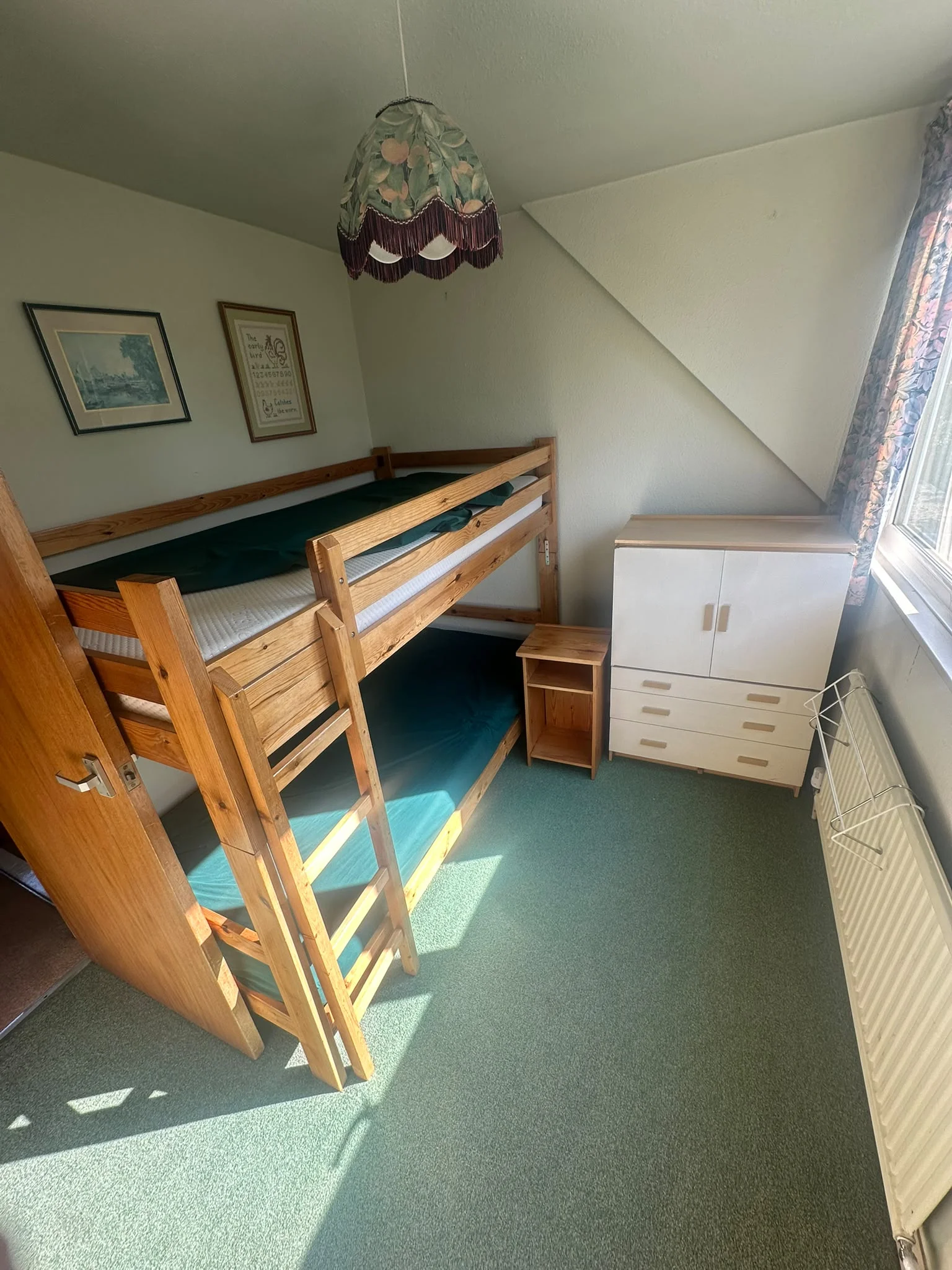 Kids bedroom before clearance with bunk beds, a wardrobe and chest of drawers