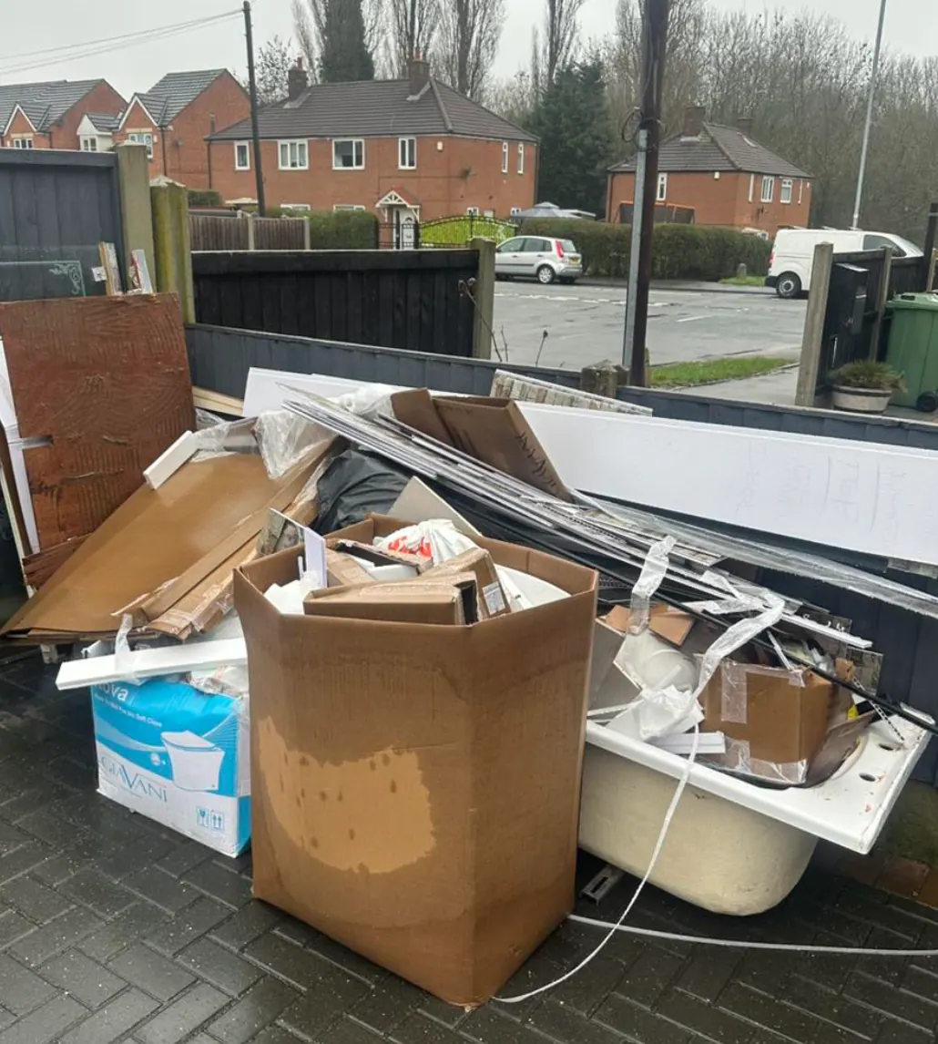 Bath shell, cardboard and bulky waste piled on a York driveway ready for Mukin pickup